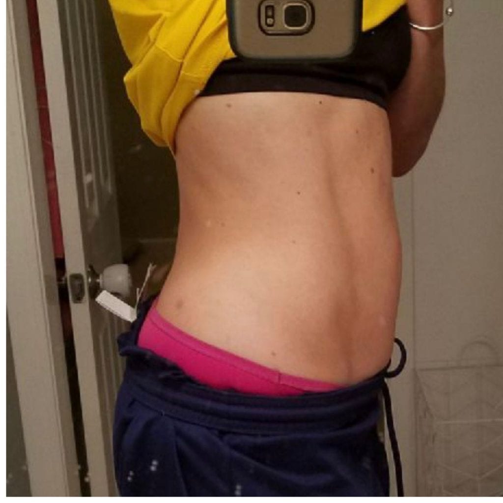 A side view picture of Kristin Larson’s abs on day 42 of Reclaim.