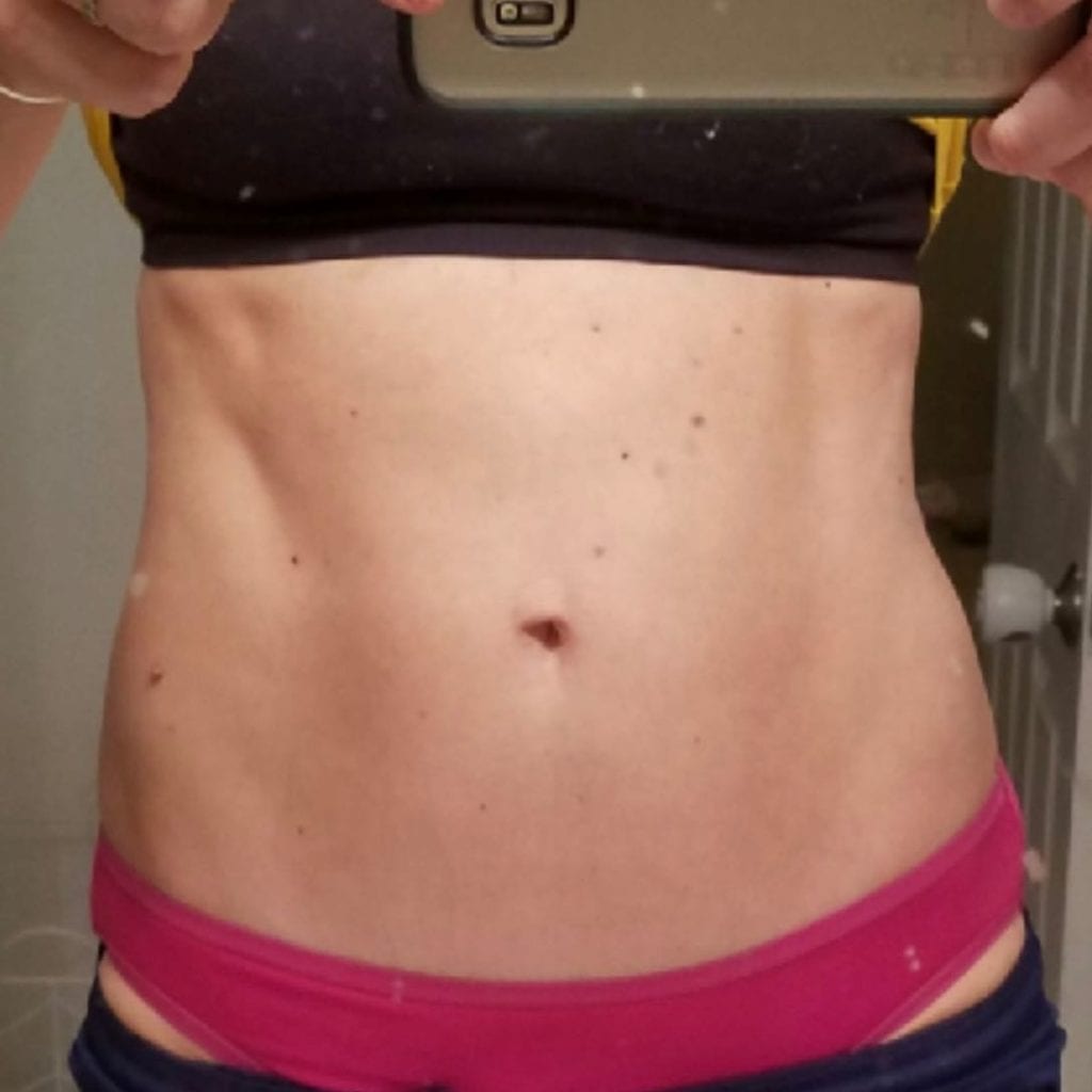 A front view picture of Kristin Larson’s abs on day 42 of Reclaim.